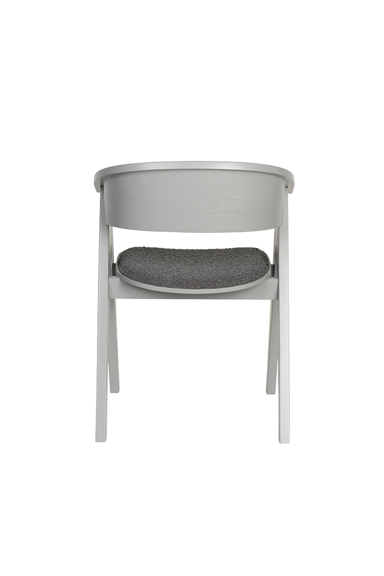 Eleganter Zuiver Ndsm Schalenstuhl mit Armlehnen, ideal für stilvolle Wohnräume und gemütliche Sitzgelegenheiten.
