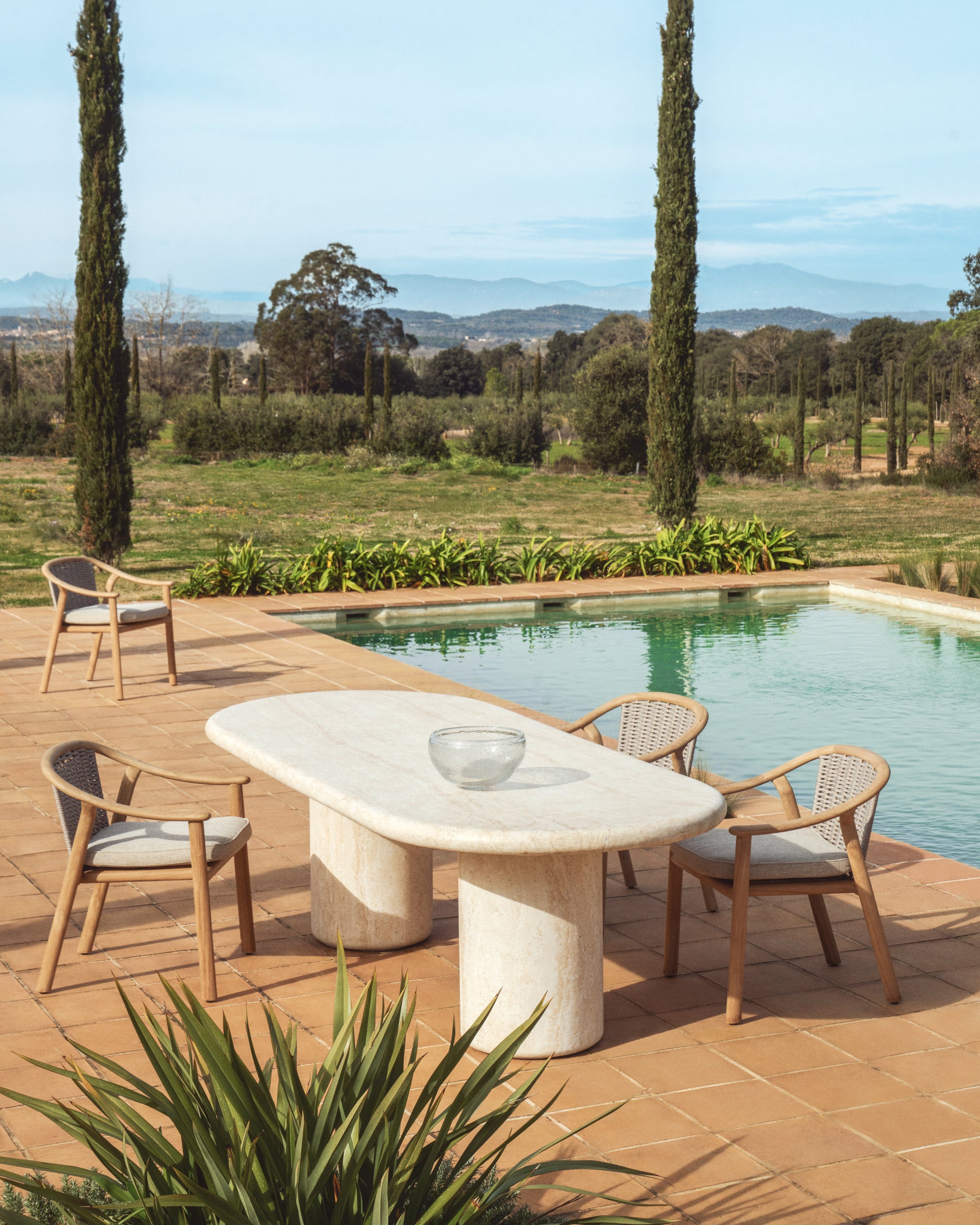 Stapelbarer Outdoor-Stuhl Elunda aus robustem Teakholz, perfekt für Garten und Terrasse, vereint Komfort und zeitloses Design.