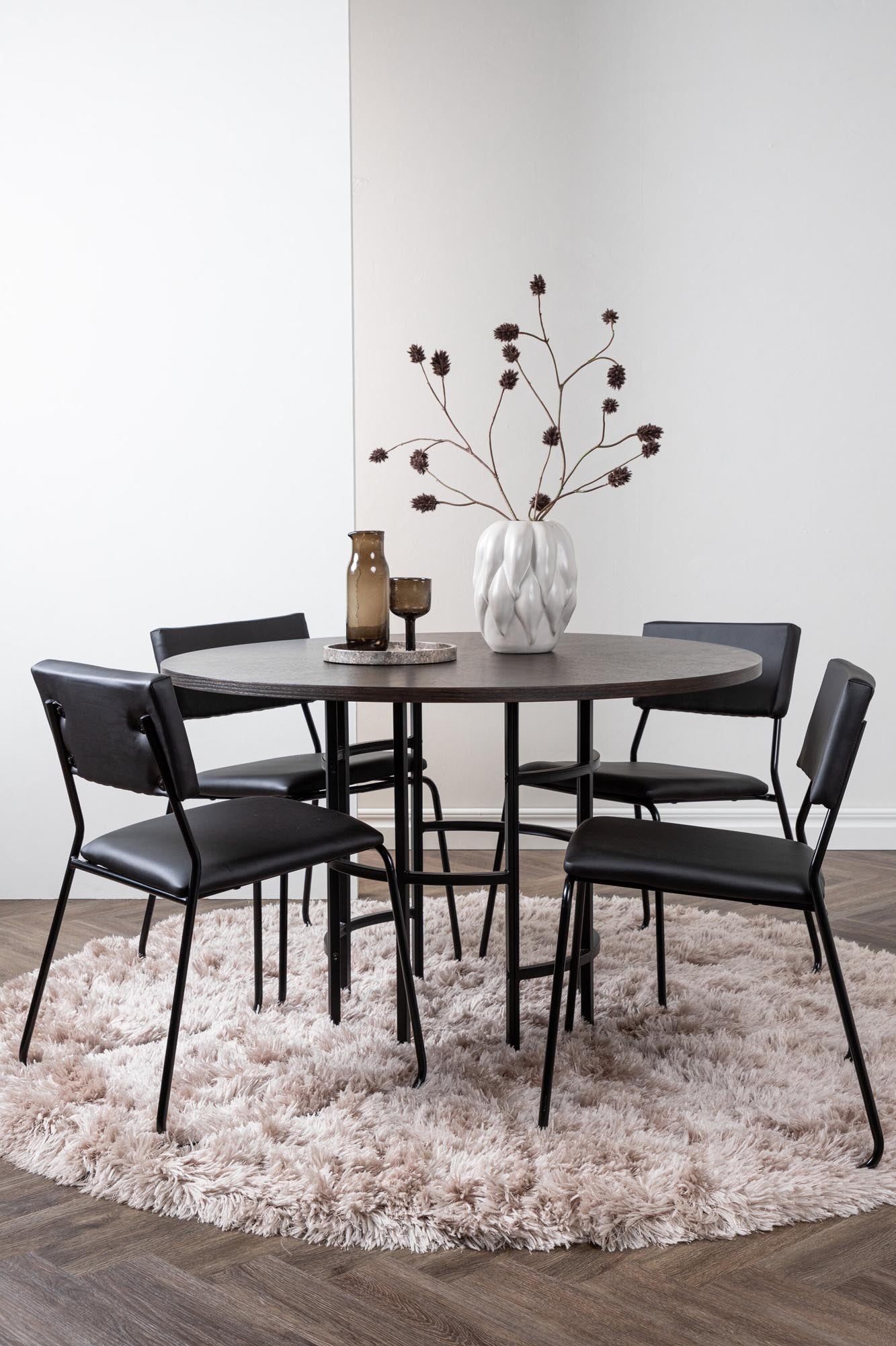 Elegantes Esszimmerset bestehend aus einem runden Tisch und vier stilvollen Stühlen, ideal für gemütliche Essbereiche.