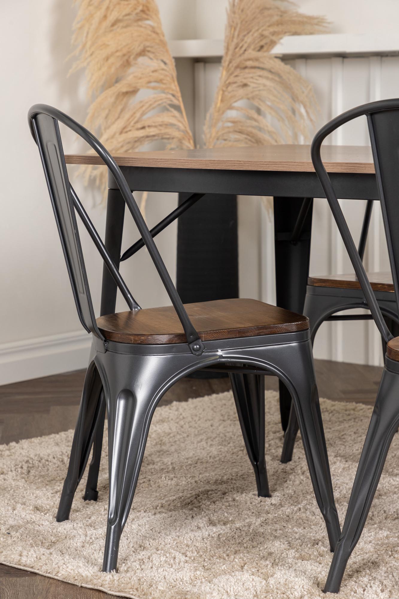 Modernes Esszimmerset Tempe mit 140 cm Tisch aus schwarzem MDF und vier stilvollen Stühlen, perfekt für gemütliche Essensrunden.
