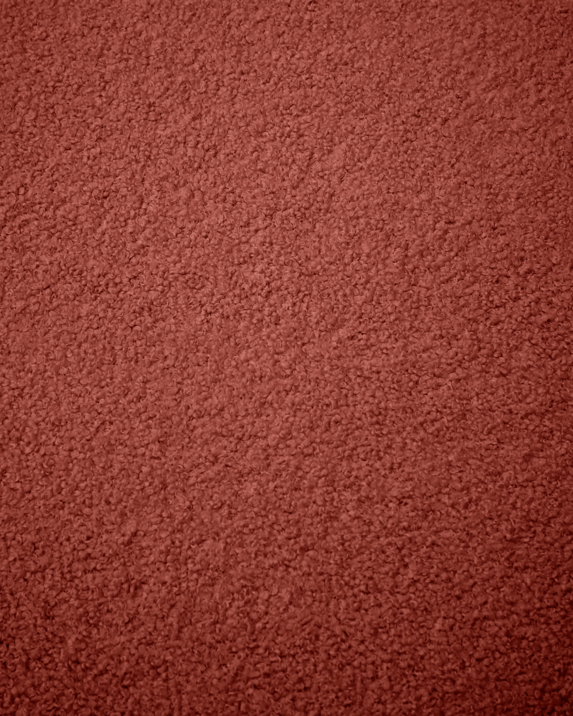 Eleganter Bezug für Fusshocker Kaeli in terrakottafarbenem Bouclé, Ø 43 cm. Ideal für stilvolle Akzente und nachhaltige Gemütlichkeit in jedem Raum.