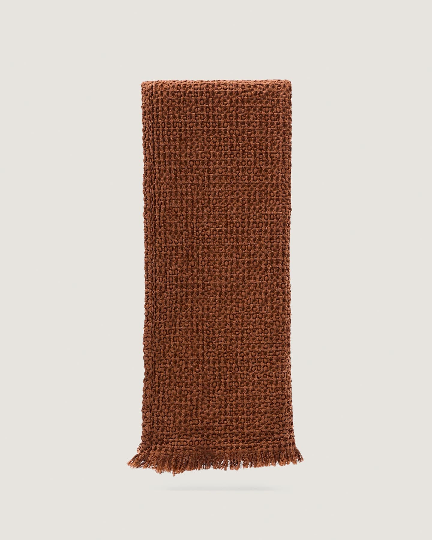 Wärmende Nulina Decke in Dunkelorange aus 100% Baumwoll-Waffelpiqué, perfekt für einladende Wohnräume. Größe: 130 x 170 cm.