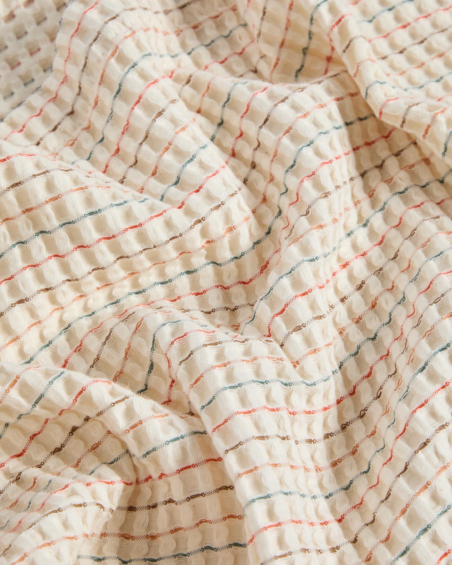 Bunte Tagesdecke Wufy aus 100 % Baumwoll-Waffelpiqué, ideal für 90 cm Betten, vereint Gemütlichkeit und modernes Design.